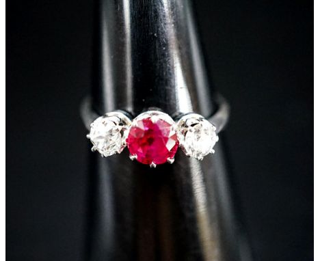 A white metal single stone ruby and two stone diamond ring, size L/M, gross weight 3 grams.