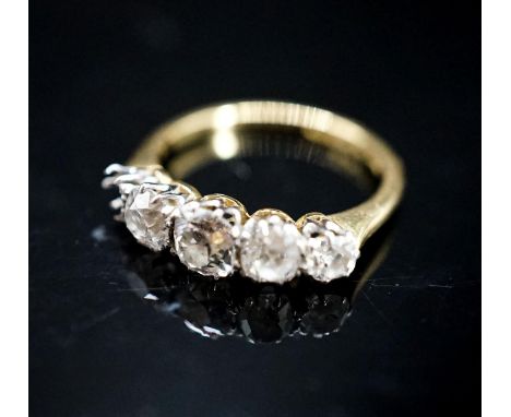 An 18ct, plat and graduated four (ex five) stone diamond set half hoop ring, size L/M, gross 2.9 grams.