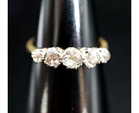 An 18ct, plat and graduated five stone diamond set half hoop ring, size N, gross 3.1 grams.