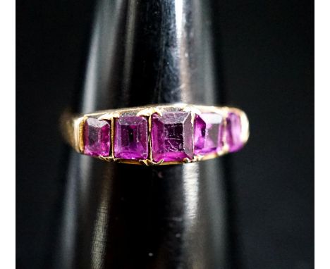 A Victorian 15ct gold and graduated five stone amethyst paste set half hoop ring, size O/P, gross 2.4 grams.