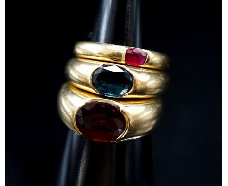 Two 18ct and gypsy set gem set rings, maker TR, size M and a similar smaller ring, size H, gross weight 20 grams.