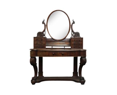 the oval mirror held in a carved superstructure fitted with six small and one long central drawer resting on a shaped top abo