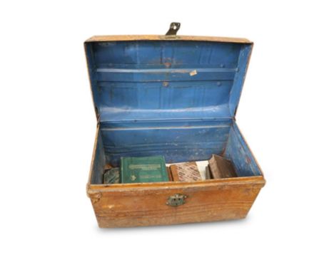 the trunk with a lift top opening to reveal a collection of books and maps