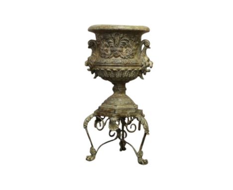 In the neoclassical taste the urn resting on a tripod base,45cm wide