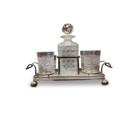 comprising of a decanter, three matching glasses and one odd glass, seated on a tray