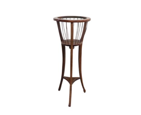 the basket top supported by three splayed legs with shelf stretcher