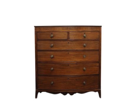 the bow fronted top, above a plain frieze, resting on two short and four long graduated drawers, all fitted with round turned