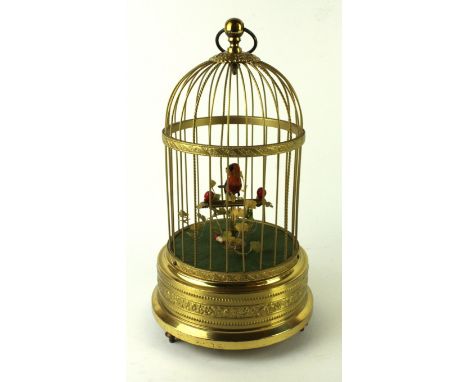 A 20th Century Swiss clockwork automaton singing bird in cageMarked to base Ivolene, 30cm high 