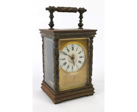A late 19th/early 20th Century French brass cased carriage clockThe case with pillared side supports, the clock with circular