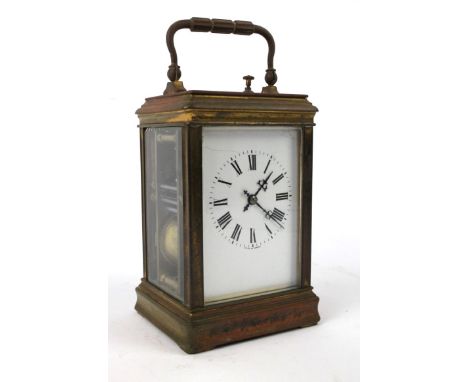An early 20th Century French brass cased carriage clockOf typical form, the clock with plain brass case and white enamel dial