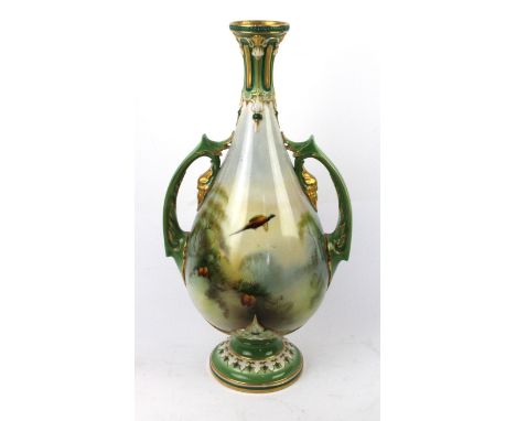 A James Hadley Royal Worcester twin handled hand painted vaseDecorated with pheasants in flight amongst foliate and landscape
