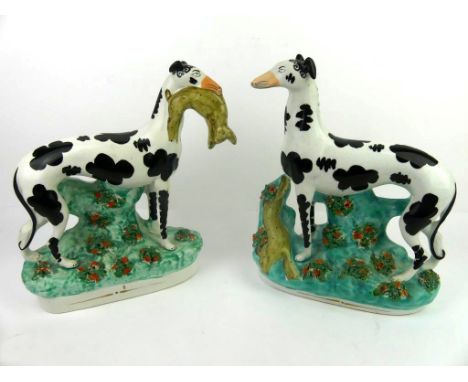 A pair of 19th Century Staffordshire Disraeli dogs'Hares and Graces', one carrying hare in mouth the second with hare on the 