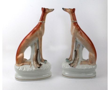 A pair of 19th Century Staffordshire GreyhoundsHigh and Mighty, circa 1860, height 33cm   CONDITION REPORT:  right example wi