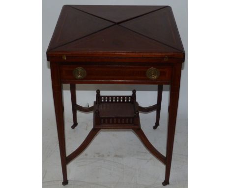An Edwardian mahogany and inlaid envelope card tableOf typical square form, the revolving top over a single frieze drawer, ra