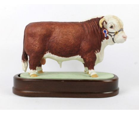 A Royal Worcester model of a Hereford BullModelled by Doris Lindner 1959, raised on oval wooden plinth base, length 25cm   CO