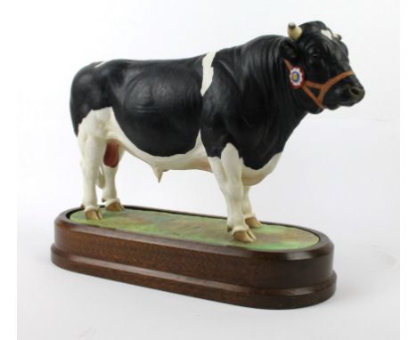 A Royal Worcester model of a British Fresian BullModelled by Doris Lindner, circa 1964, raised on oval wooden plinth base, le