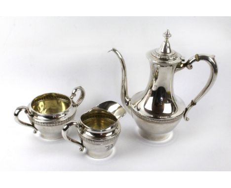 An early 20th Century American three piece silver coffee setDecorated with floral banding, comprising coffee pot, milk jug an