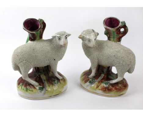 A pair of 19th Century Staffordshire spill vasesModelled in the form of sheep, raised on naturalistic plinth bases, circa 189