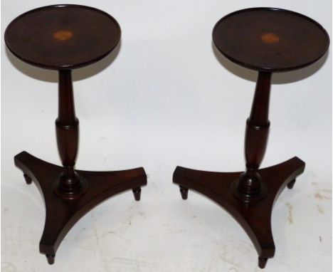A pair of small 19th Century mahogany plant stands/lamp tablesWith circular tops raised on turned column and three footed bas