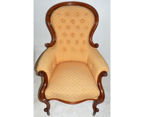 A Victorian button upholstered armchairWith mahogany show wood frame, height 106cm, width 74cm, depth 65cm