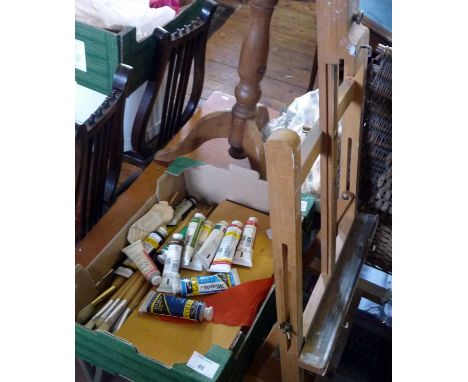 Assorted artists materials and an easel