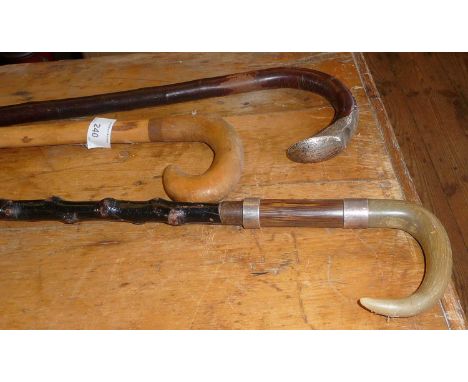 2 Horn handled walking sticks, one with silver bands and another silver mounted walking stick (3)