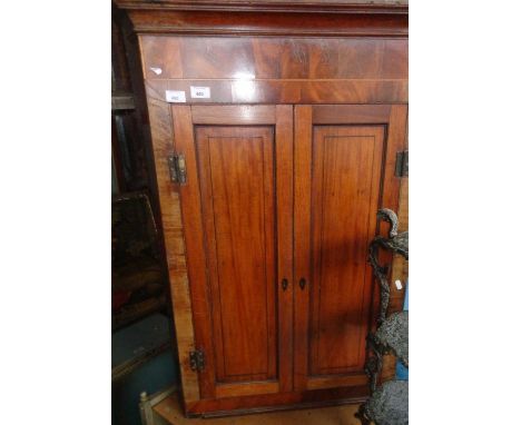 Early 19th c. mahogany two-door corner cupboard enclosing shaped shelves