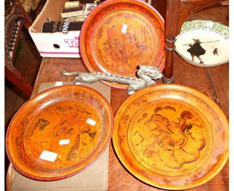 Three Chinese painted wood dishes, 28cm diameter, and a Chinese bronze dragon, 32cm long