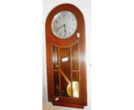 Oak cased wall clock with glazed door