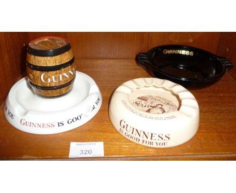 Two Guinness advertising china ashtrays and a Mintons Ltd. china Guinness advertising ashtray with a beer barrel shaped match