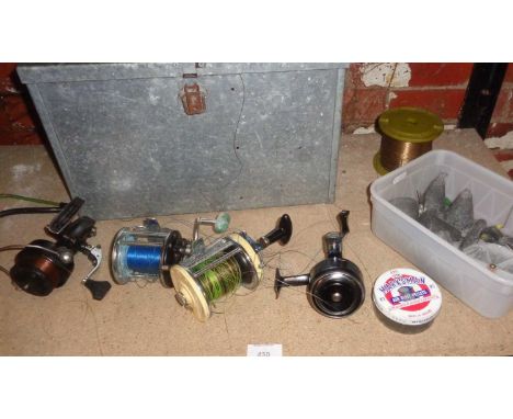 Four various fishing reels and accessories in tin box