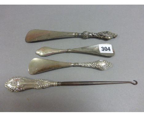 Three Silver Handled Shoe Horns and a Silver Handled Button Hook