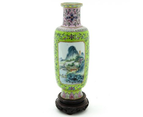 Light green ground with Famille Rose enamels depicting florals and landscape scenes, marked Qianlong, vase is 20 cm. tall. 