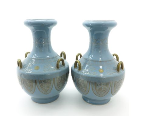 Light blue glaze ground with gold gilt decor of Chinese symbols with dragons, each vase with 4 gold gilt handles, marked on b