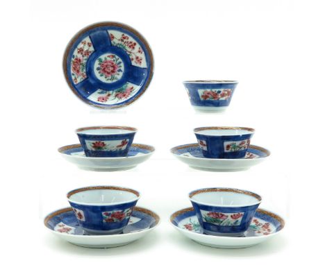 Powder blue ground with Famille Rose floral enamels, 18th Century, saucers are 11 cm. in diameter, some with small chips on r