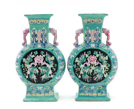 Light green ground with Famille Rose enamels depicting florals with phoenix, dragon handles, 22 cm. tall.