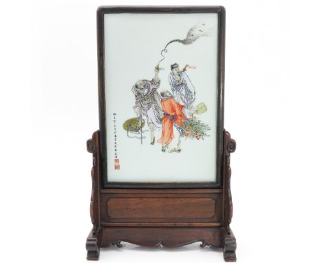 Depicting Chinese men burning incense, in carved wood frame with stand, signed with 2 Chinese seals, tile measures 27 x 39 cm