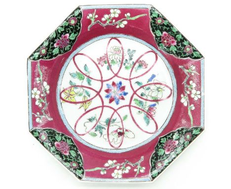 Ruby ground with floral Famille Rose enamels, 19 cm. in diameter, hairline.