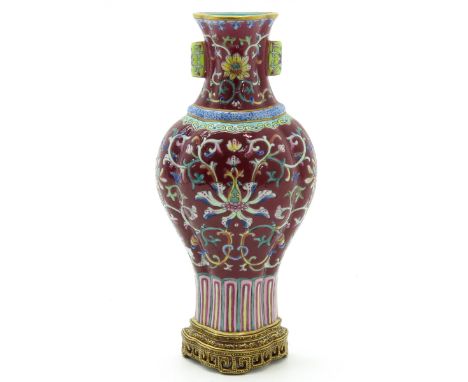 Ruby ground with Famille Rose enamels, marked Qianlong, 21 cm. tall.