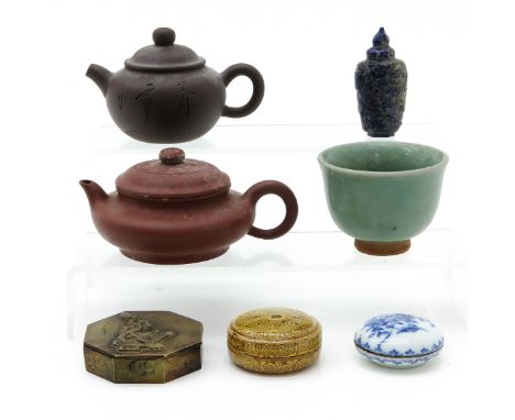 7 diverse pieces, including 2 yixing teapots, 3 covered boxes, snuff bottle, and celandon cup, tallest teapot is 8 cm.