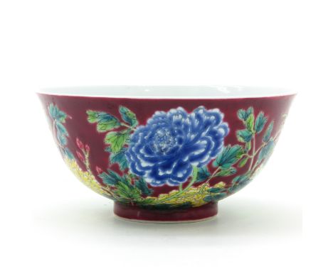 Ruby ground with polychrome decor of flowers, 15 cm. in diameter.