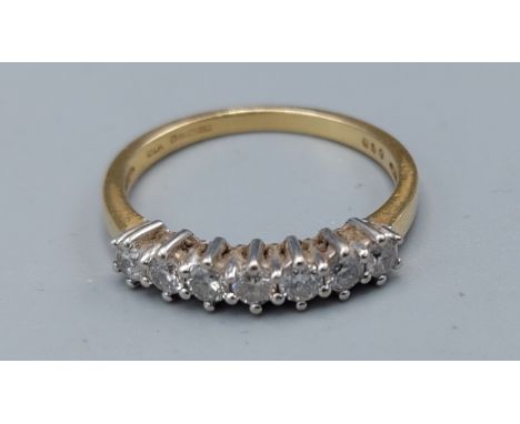 An 18ct yellow gold ring set with seven diamonds with in a pierced setting, approximately 0.50ct, ring size P, 3gms 