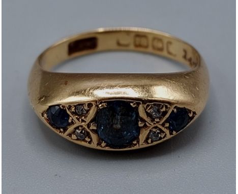 An 18ct gold ring set with three Sapphire and four small Diamonds, 4.3gms, ring size J 