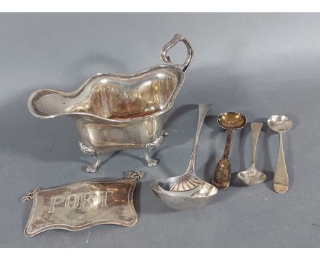 A Sheffield silver jug together with a London silver decanter label, three silver mustard spoons and a Georgian silver ladle,