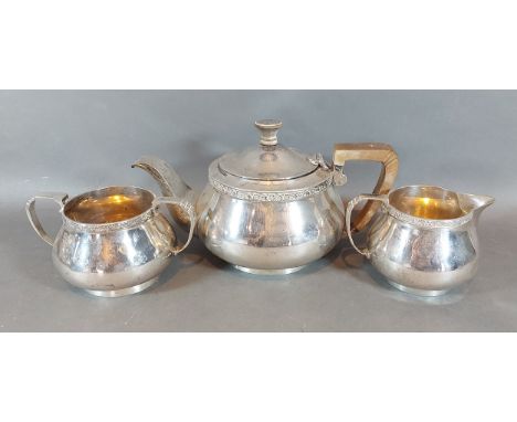 An Art Deco London silver three piece tea service comprising, teapot, cream jug and two handled sucrier, 28ozs 