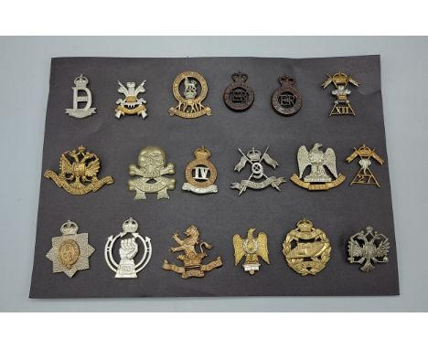 A collection of eighteen British Army Regimental cap badges to include Royal Scots Tank Corp 