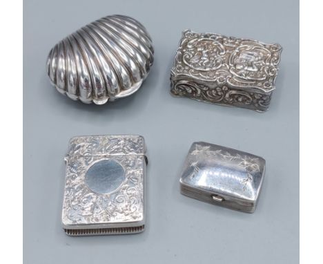 A London silver snuff box of embossed form together with a 925 silver snuff box of scallop form, a London silver pill box and