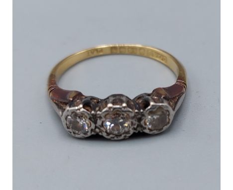 An 18ct gold and Platinum three stone Diamond ring, 2.8gms, ring size J 