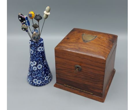 A Victorian jewellery box together with a collection of hat pin within a ceramic stand 