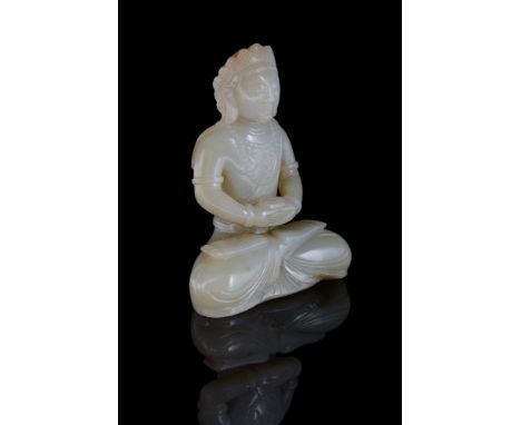 A Chinese celadon jade seated buddha, 19th or 20th century, carved seated in dhyanasana, wearing long robes draped over his s